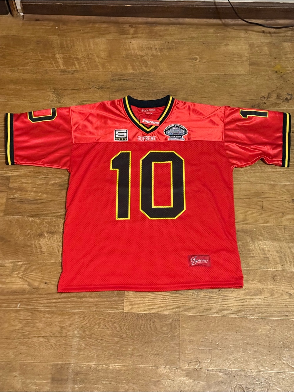 Red mesh top with Supreme label